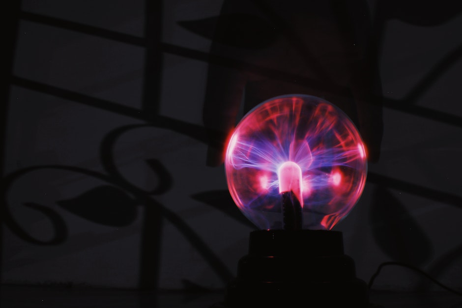 Glowing plasma ball with red light in dark room