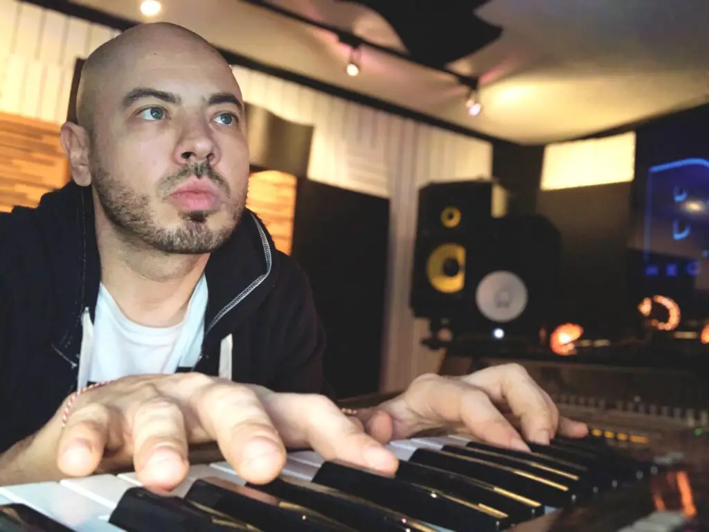 a man with a bald haircuts - File:Grammy Award Winning Music Producer Drew Correa, Composing music.j