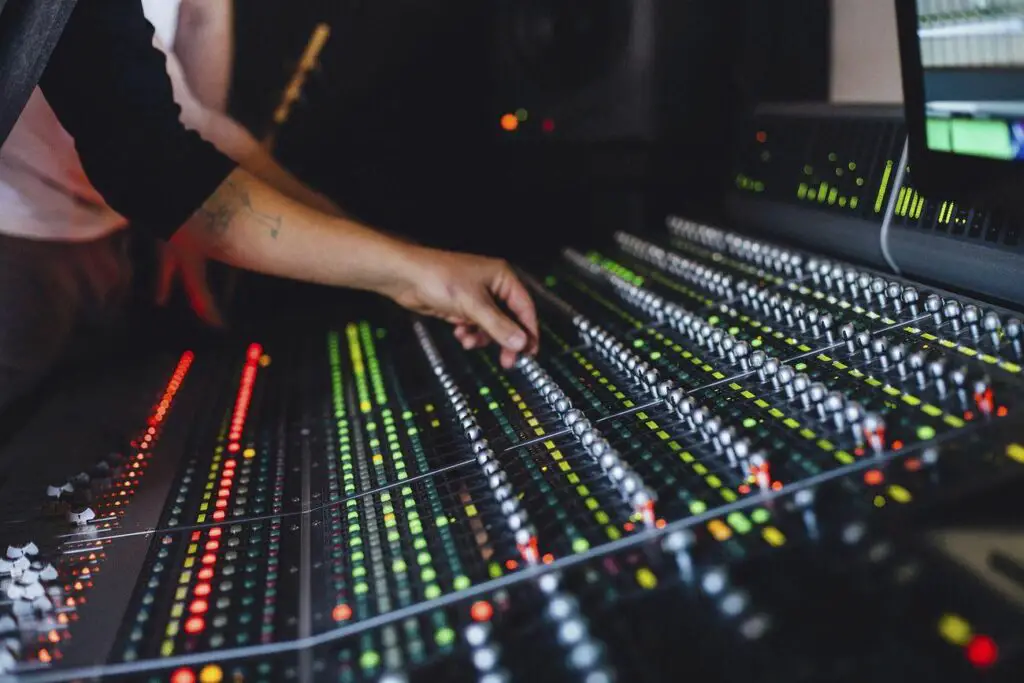 Free music producer photo - a man in a recording room with a mixing board