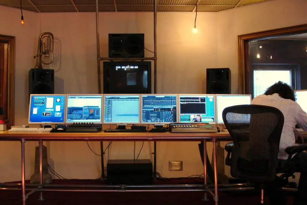 File:Gooi & Vecht Studio, Audio 1 control room with Nuendo 6.5.jpg - a man sitting at a desk with tw