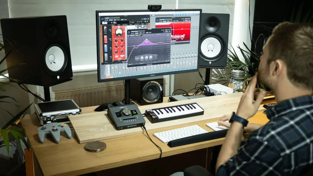 File:Logic PRO X Tutorial.png - a man sitting at a desk with a computer and a keyboard
